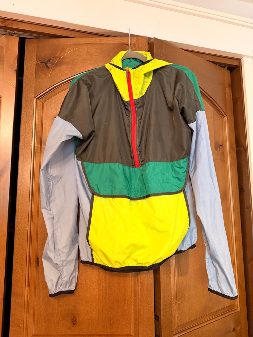 cotopaxi teal green and neon yellow jacket with red trim